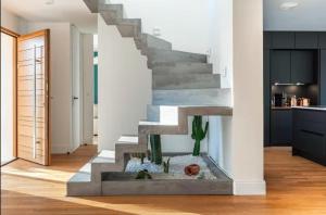 a living room with a fish tank under a staircase at House Moringa Rituals Pool in Le Plessis-Trévise