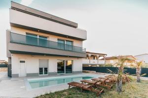a villa with a swimming pool and a house at Villa Aura Vir in Vir