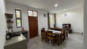 a kitchen and dining room with a table and chairs at 2BR Apartment in Tanga in Tanga