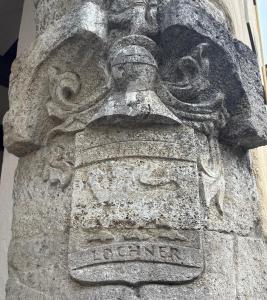 a stone statue of a head on the side of a building at Ankerplatz in Münnerstadt