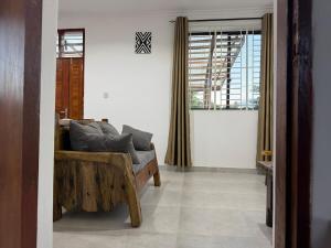 a living room with a couch and a window at 2BR Apartment in Tanga in Tanga