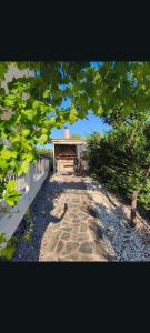 a stone walkway leading to a house with a roof at villa sun view in Peratiá