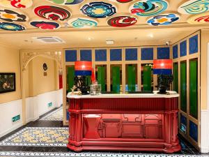 a red bar in a room with a colorful ceiling at Eliana Robusta Hotel in Hanoi +145 photos