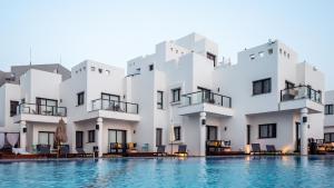 a building with a pool in front of it at Jacob Sea Life Nahariya in Nahariyya