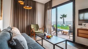 a living room with a couch and a table at Jacob Sea Life Nahariya in Nahariyya