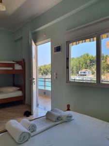 a bedroom with a bed and a view of a balcony at Ionian Balcony in Himare +49 photos