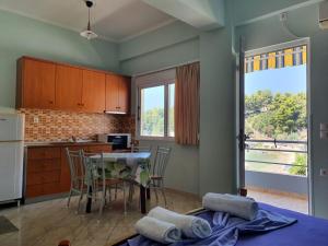 a kitchen and dining room with a table and chairs at Ionian Balcony in Himare