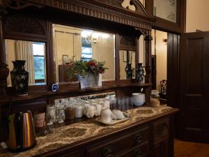 a kitchen counter with a sink and a mirror at Lochinvar House in Lochinvar