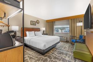 a hotel room with a bed and a tv at Best Western Plus GranTree Inn in Bozeman