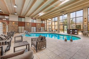 a pool in a hotel room with tables and chairs at Best Western Plus GranTree Inn in Bozeman