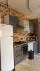 a kitchen with stainless steel appliances and a white refrigerator at S1 hammamet mrezga in Nabeul