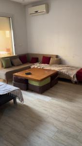 a living room with a couch and a coffee table at S1 hammamet mrezga in Nabeul