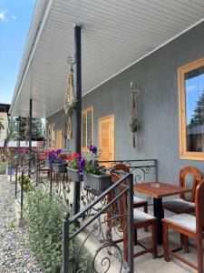 a patio with a table and chairs and flowers at Dream Guest House in Bosteri