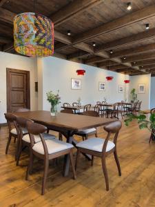 a dining room with a large wooden table and chairs at Lasiim in Mestia +45 photos