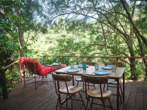 a wooden deck with a table and chairs at Villa Rock Stop Falls Gigiri in Nairobi