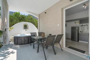 a kitchen and dining room with a table and chairs at 30Roses House in Sálakos