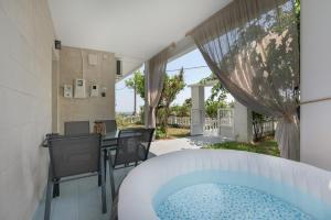 a hot tub in the backyard of a house at 30Roses House in Sálakos