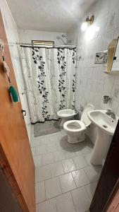 a bathroom with a toilet and a sink and a shower at maica's apartment in Taytay