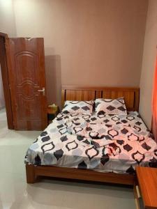 a bedroom with a bed with a comforter on it at maica's apartment in Taytay