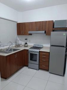 a kitchen with a stove and a refrigerator at maica's apartment in Taytay