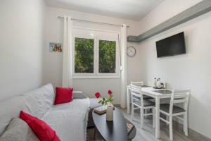a living room with a couch and a table at 30Roses House in Sálakos