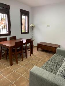 a living room with a table and a couch at Hostel Los Guajares in Guájar-Faragüit