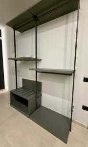 a glass shelf in a room with a wall at H Luxury Apartment Crispi in Olbia
