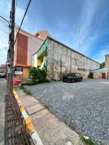 a car parked in a parking lot next to a building at The See Stay Hatyai in Hat Yai