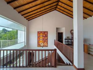 a room with a staircase and a large window at Sky Lodge in Kandy