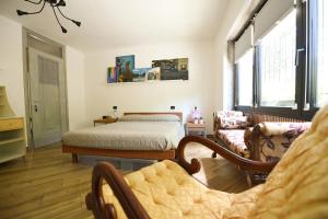 a bedroom with a bed and a living room at Casa Vacanza La Torre in Paratico