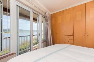 a bedroom with a bed and a large window at Ilse's Garden Route Gem in Knysna