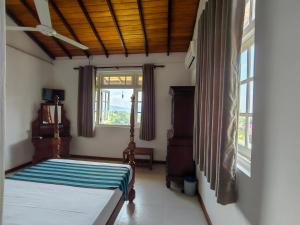 a bedroom with a bed and a window at Sky Lodge in Kandy +63 photos