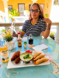 a woman sitting at a table with a tray of food at bon Appetit Hotel restaurant barahona in Isleta de Barahona