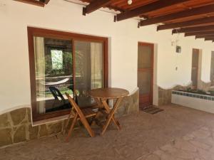 a wooden table and chair on a patio at Hotel el Amanecer in Samaipata