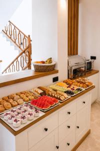 a buffet line with many different types of pastries at Melitti Lucent in Rethymno
