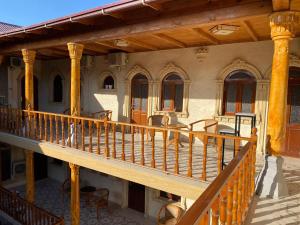 a balcony of a building with a wooden deck at El Emir in Samarkand +10 photos