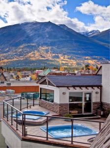 a view of a mountain from a house with two swimming pools at Whistler's Inn in Jasper