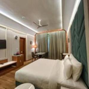 a hotel room with a bed and a desk at Hotel Imperial Blu in Similigurha