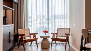 a room with chairs and a table and a large window at Jacob Modiin in Modi'in-Maccabim-Re'ut