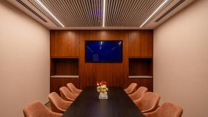 a conference room with a table and chairs and a tv at Jacob Modiin in Modi'in-Maccabim-Re'ut