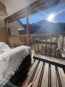 a bedroom with a bed on a balcony with a view at Altitude 875 in Arrens-Marsous