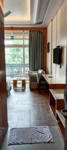 a living room with a large window and a couch at Hotel Imperial Blu in Similigurha