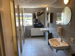 a bathroom with two sinks and a mirror at Sky Airplane in Tilburg