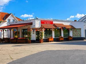 a building with a store with flowers in front of it at Motel Witnica in Witnica