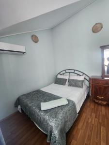 a bedroom with a bed and a wooden floor at Apartment Ureki in Ureki