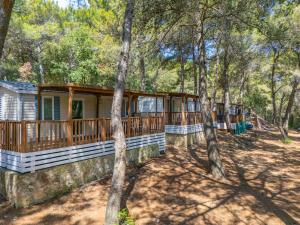 a large house in the woods with trees at Mobile homes Pine Sea Banjole in Banjole +42 photos