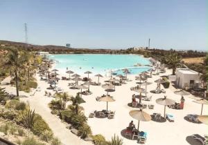 an overhead view of a pool with umbrellas and chairs at The Lagoon Apartment- Free Lagoon Access in Estepona