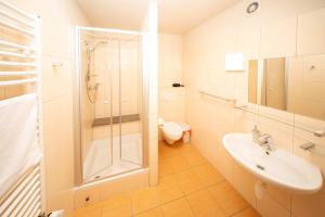 a bathroom with a shower and a sink and a toilet at Zawoja1560 Apartamenty przy Aptece in Zawoja +33 photos