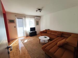 a living room with a couch and a table at Stan Foca N in Foča