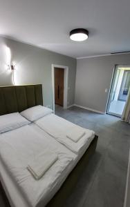 a bedroom with a large bed in a room at Olimp Apartamenty in Konin